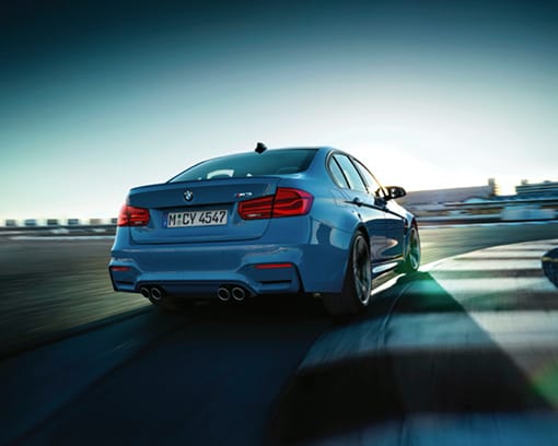 Rear shot of a BMW M3 driving on the race track