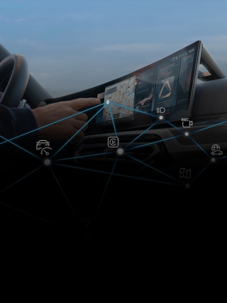 Interior shot of a BMW driver interacting with BMW Connected Drive technology, with an overlay graphic showing Connected Drive icons connected with blue lines