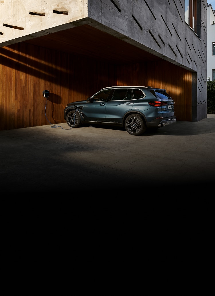 A 2024 BMW X5 xDrive50e charges at home with the BMW Wallbox charger.
