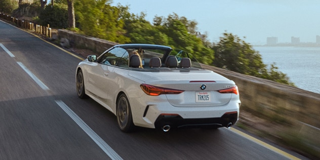 Rear view of a BMW driving on a scenic highway