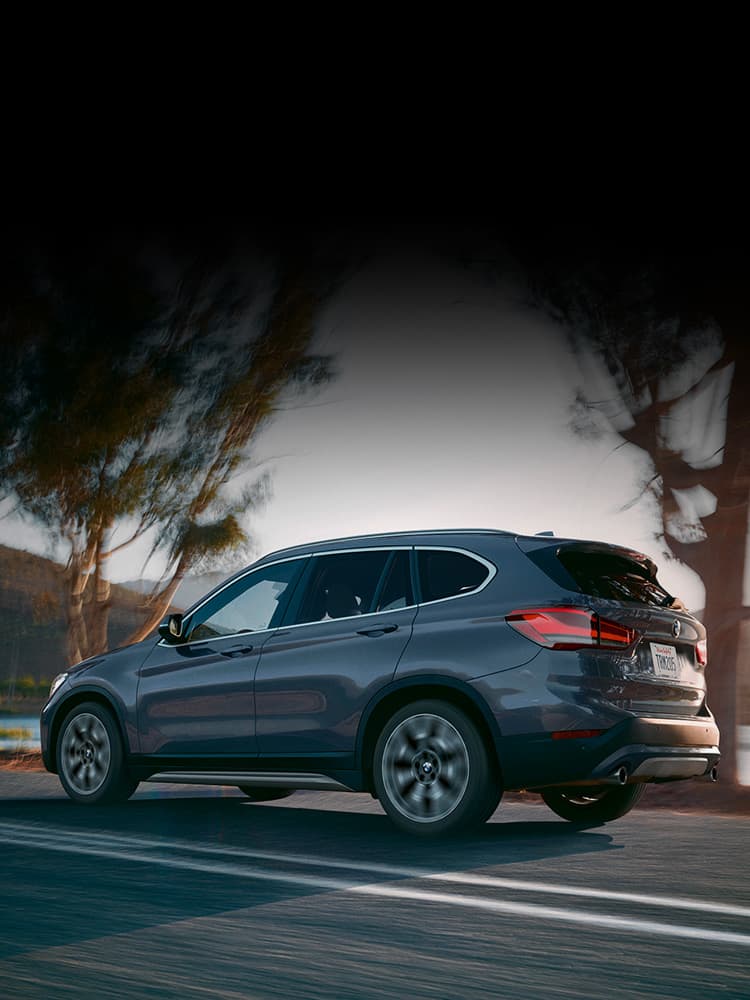 A BMW Driving down the street.