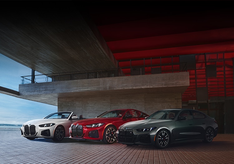 The 4 Series Coupe, the 4 Series Convertible, and the 4 Series Gran Coupe parked together on the top deck of a garage