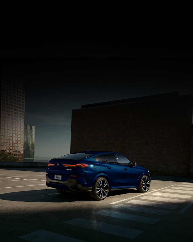 The 2026 BMW X6 M Competition Performance Coupe SUV parked in an urban parking garage